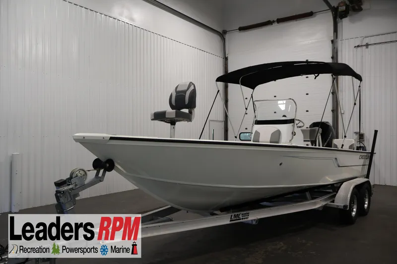 The Image of 2022 Crestliner 2200 Bay boat on trailer in indoor showroom. - 2