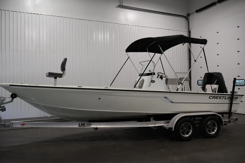 Slide: The Image of 2022 Crestliner 2200 Bay boat on trailer in indoor storage. - 9