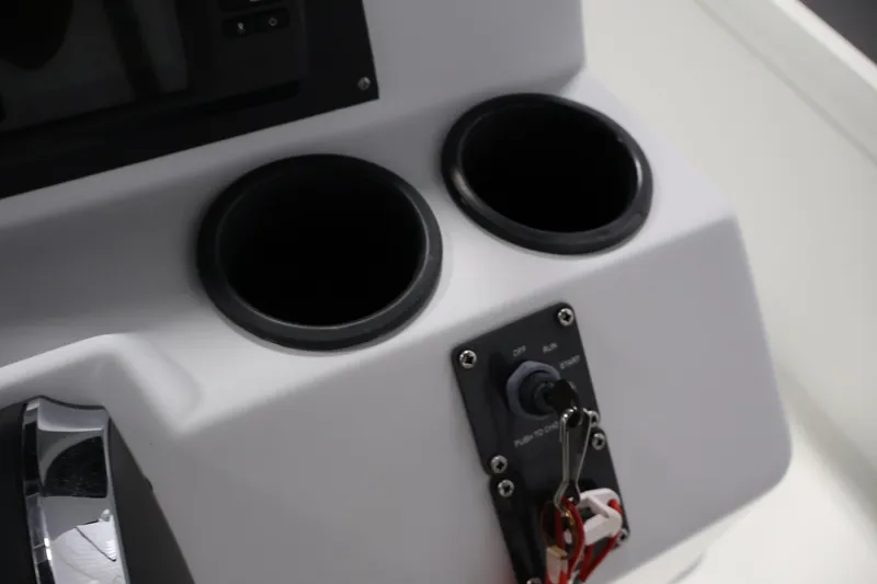 Slide: The Image of Console of 2022 Crestliner 2200 Bay boat with cup holders and ignition switch. - 29