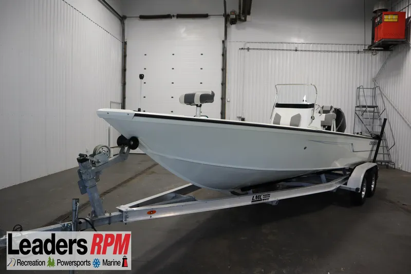 The Image of 2022 Crestliner 2200 CC boat on trailer in indoor showroom. - 1