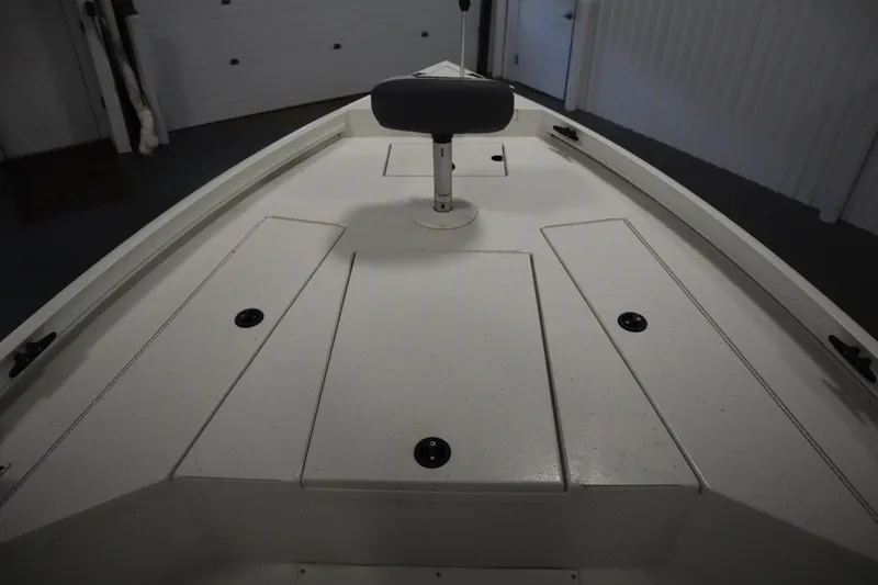 Slide: The Image of 2022 Crestliner 2200 CC boat deck with storage compartments and seat. - 11