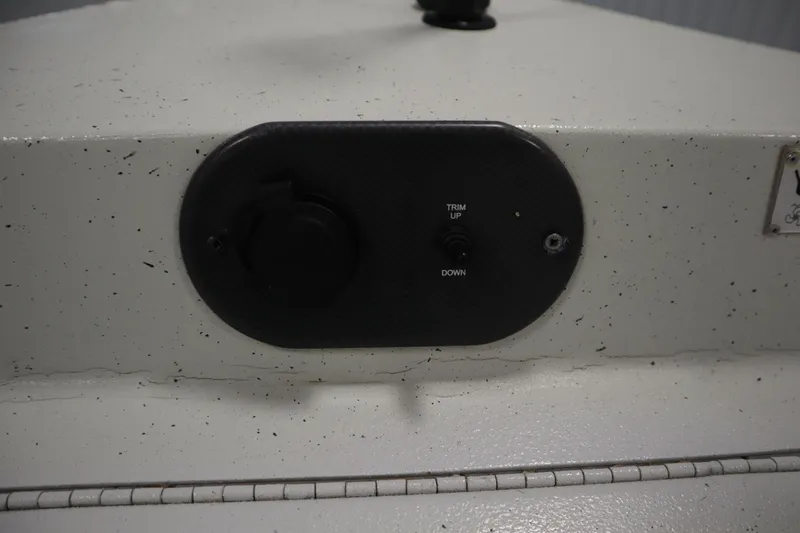 Slide: The Image of Control panel on 2022 Crestliner 2200 CC boat with trim adjustment switch. - 12