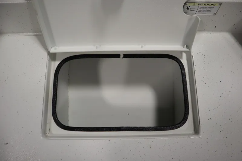 Slide: The Image of Open storage compartment on 2022 Crestliner 2200 CC boat, featuring a white interior. - 14