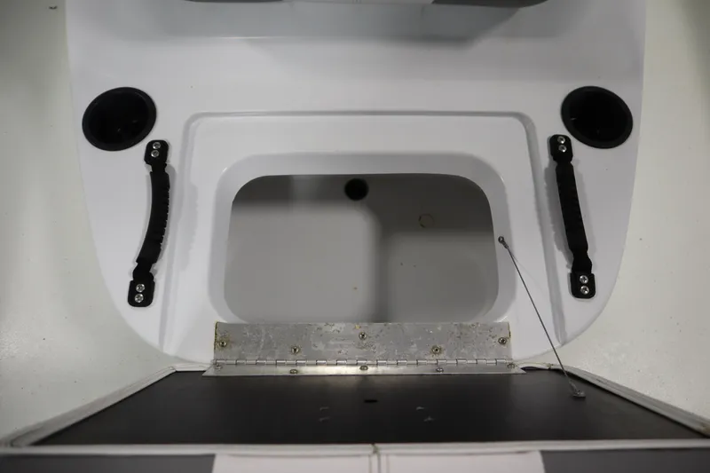 Slide: The Image of 2022 Crestliner 2200 CC boat storage compartment with handles and cup holders. - 20