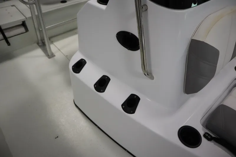 Slide: The Image of 2022 Crestliner 2200 CC boat interior with rod holders and seating. - 22