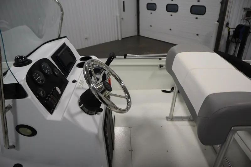 Slide: The Image of 2022 Crestliner 2200 CC boat interior with steering wheel and dashboard controls. - 23