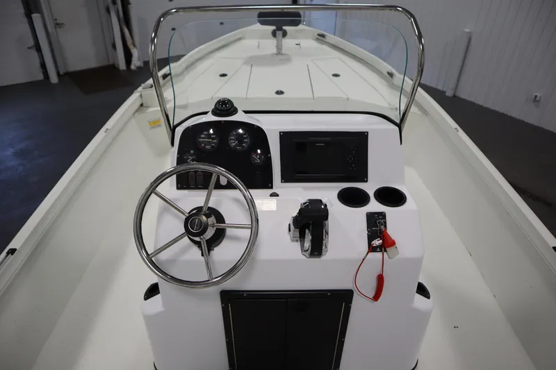 Slide: The Image of 2022 Crestliner 2200 CC boat console with steering wheel and controls. - 24