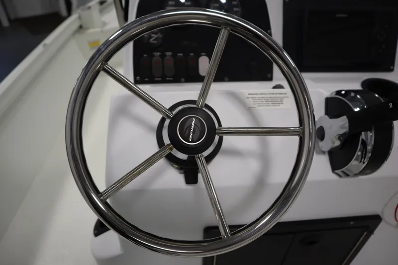 Slide: The Image of Steering wheel of 2022 Crestliner 2200 CC boat, featuring sleek chrome design. - 25