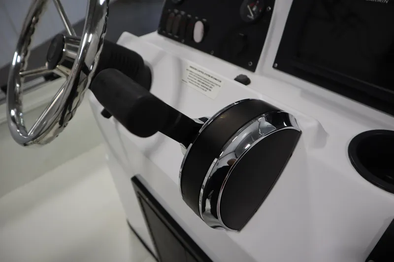Slide: The Image of Steering console of 2022 Crestliner 2200 CC boat with chrome accents. - 28