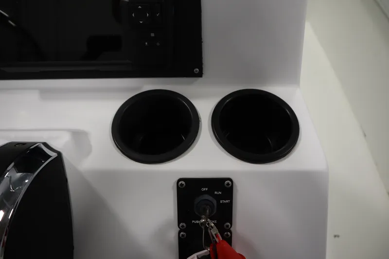 Slide: The Image of 2022 Crestliner 2200 CC boat console with cup holders and ignition switch. - 29