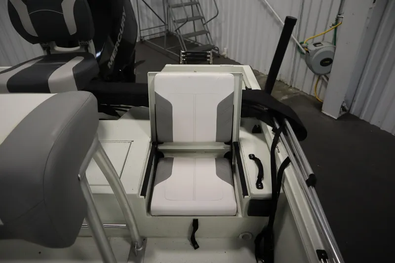 Slide: The Image of 2022 Crestliner 2200 CC boat interior with foldable seating and Mercury engine. - 34