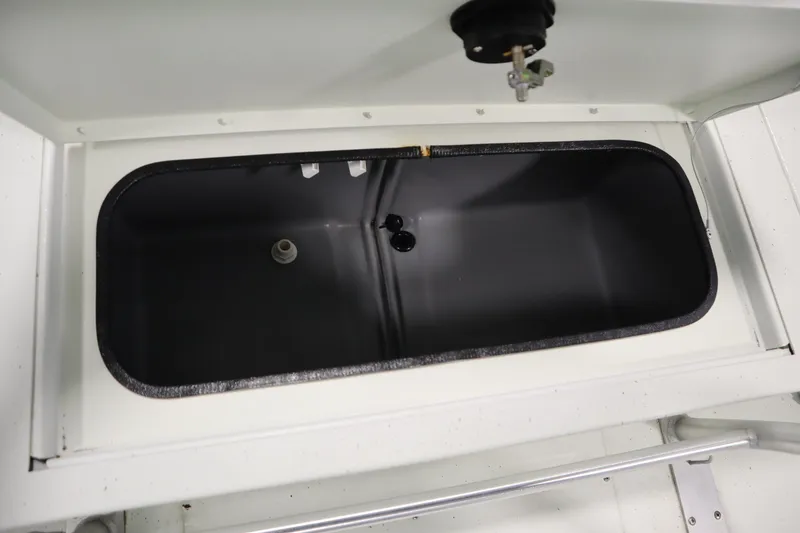 Slide: The Image of Livewell compartment in 2022 Crestliner 2200 CC boat, open lid view. - 38