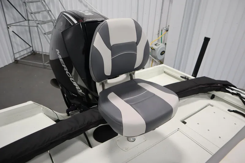 Slide: The Image of 2022 Crestliner 2200 CC boat seat with Mercury outboard motor in a garage setting. - 39