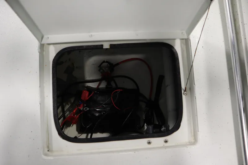 Slide: The Image of Open compartment with wiring inside a 2022 Crestliner 2200 CC boat. - 41
