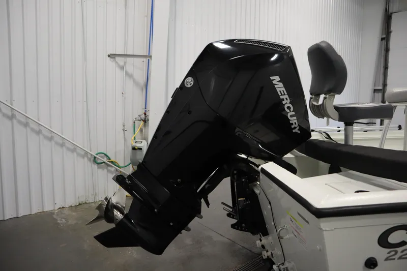 Slide: The Image of 2022 Crestliner 2200 CC boat with Mercury outboard motor in a garage setting. - 46
