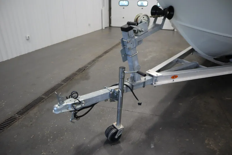 Slide: The Image of Trailer hitch of a 2022 Crestliner 2200 CC boat in a garage setting. - 48