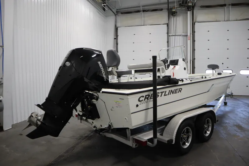 Slide: The Image of 2022 Crestliner 2200 CC boat on trailer in indoor storage. - 5