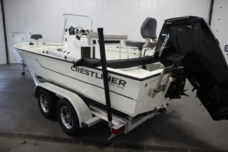 Slide: The Image of 2022 Crestliner 2200 CC boat on trailer in indoor storage. - 7