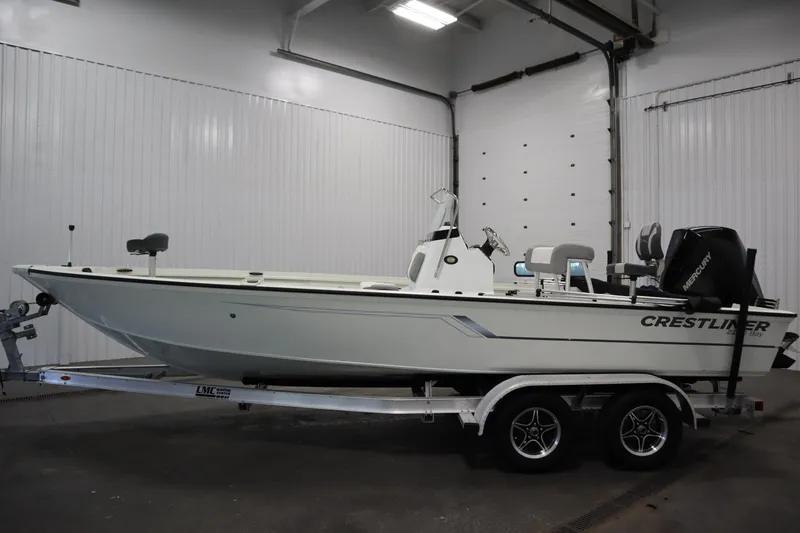 Slide: The Image of 2022 Crestliner 2200 CC boat on trailer in indoor storage. - 8