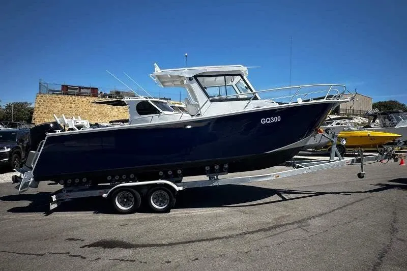 Slide: The Image of Trailer-mounted 2026 33rd Strike Group FOX-3637 boat under clear blue sky. - 23
