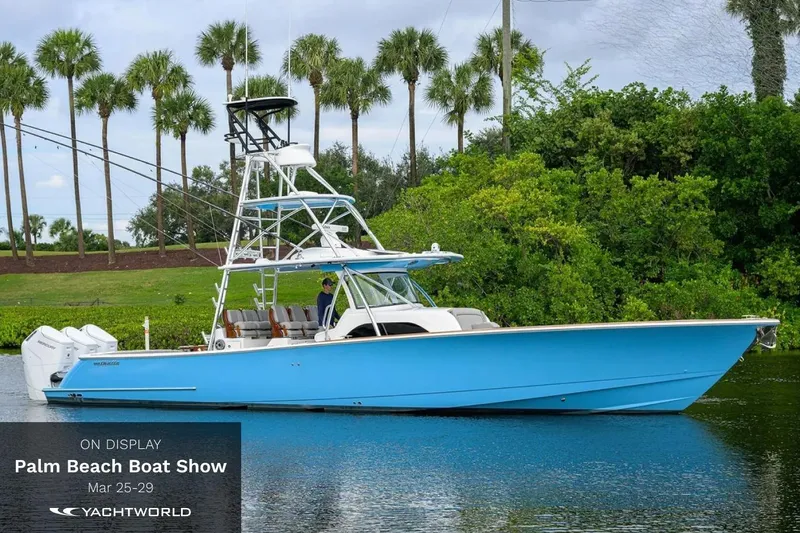 Slide: The Image of Blue 33rd Strike Group FOX-3637 boat at Palm Beach Boat Show 2026, surrounded by palm trees. - 73