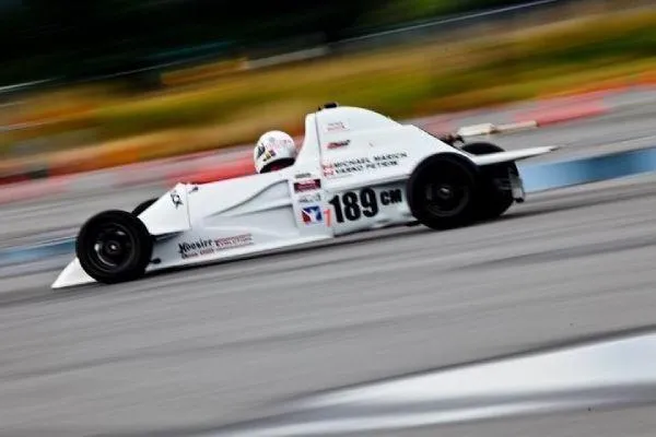 Slide: The Image of White race car, 33rd Strike Group FOX-3637, speeding on track, number 189, 2026 model. - 79