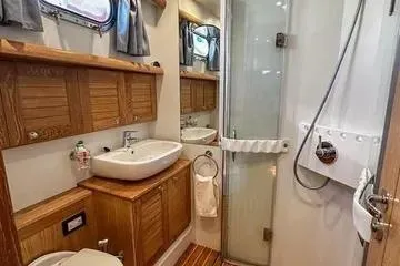 Slide: The Image of Modern bathroom in 33rd Strike Group FOX-3637, 2026 model, featuring wooden cabinetry and glass shower. - 81