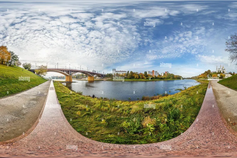 Slide: The Image of Panoramic view of a scenic river, bridge, and lush greenery under a cloudy sky. - 93