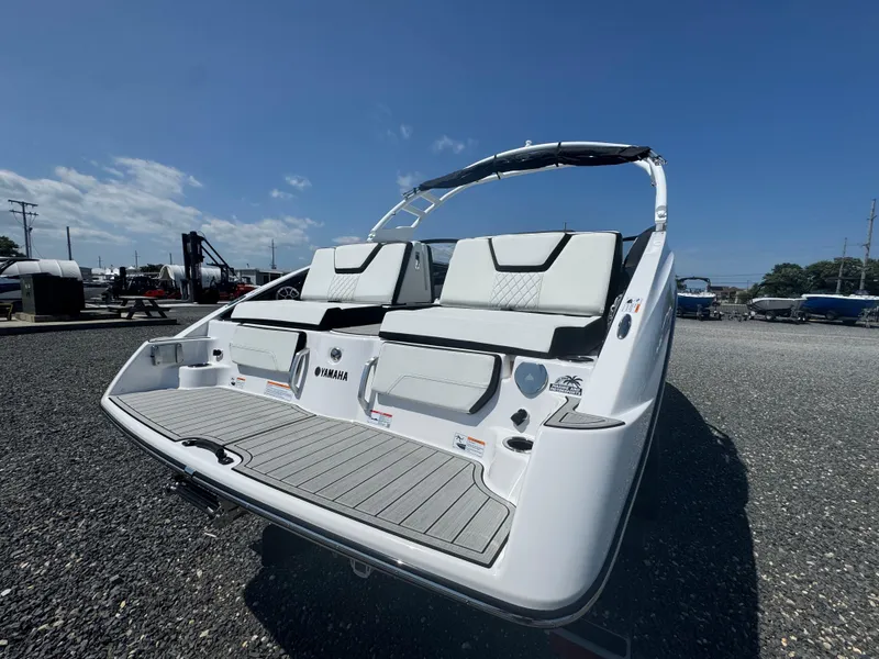 Slide: The Image of 2025 Yamaha Boats 252S, sleek design, rear view, outdoor display, clear sky. - 16