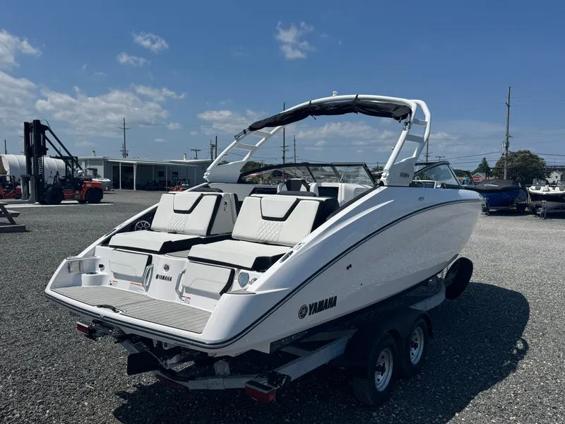 Slide: The Image of 2025 Yamaha Boats 252S on trailer, sleek design, white exterior, outdoor display. - 3