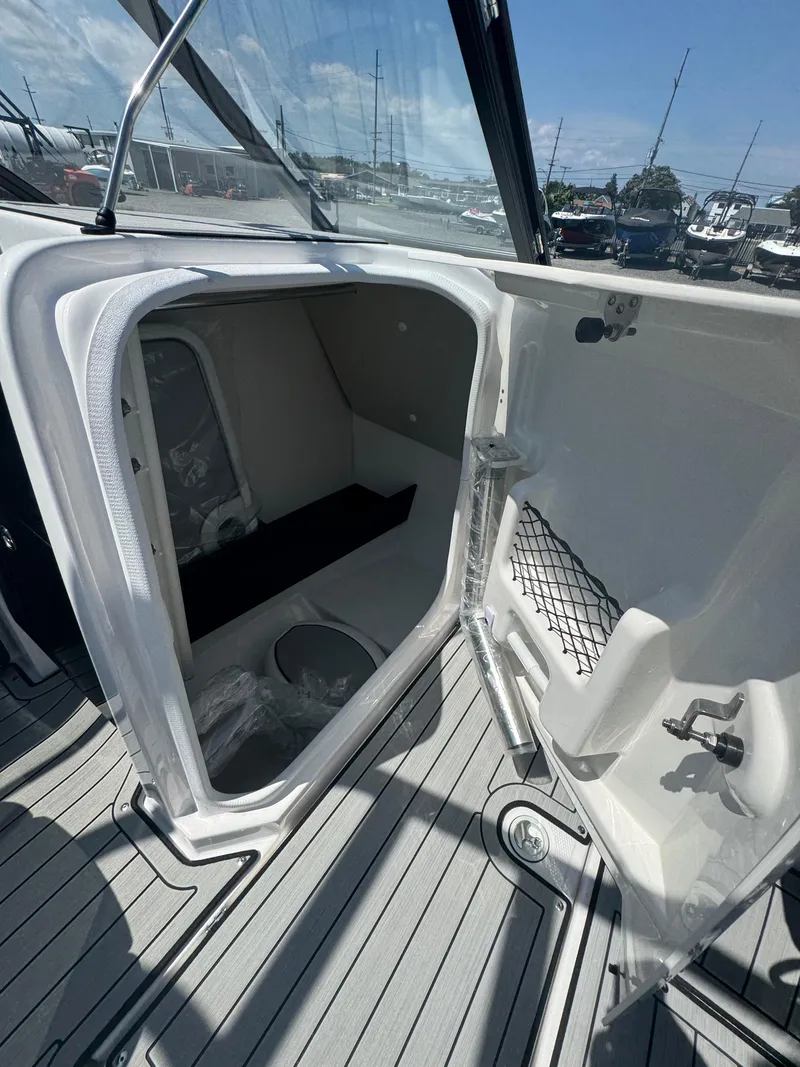 Slide: The Image of 2025 Yamaha Boats 252S interior cabin with open door, showcasing sleek design and modern features. - 8