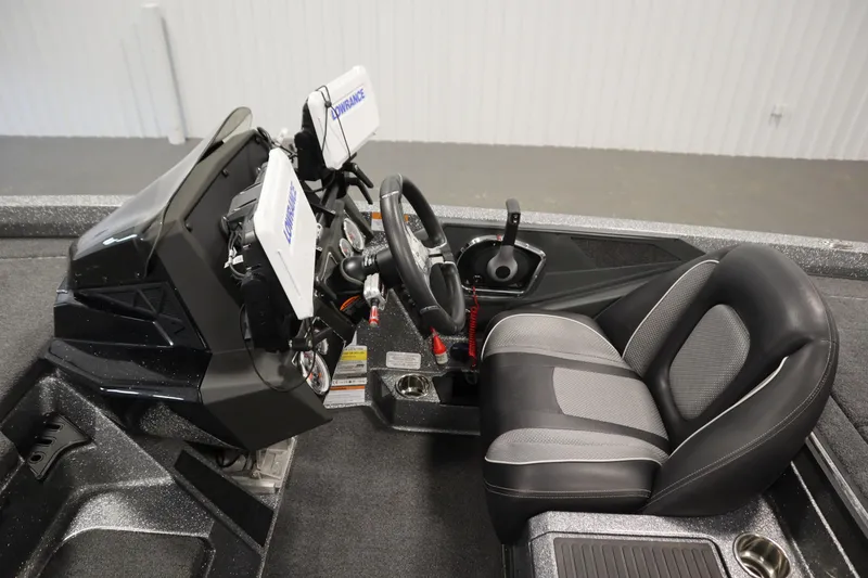 Slide: The Image of 2023 Ranger Z519 boat cockpit with steering wheel and navigation equipment. - 27