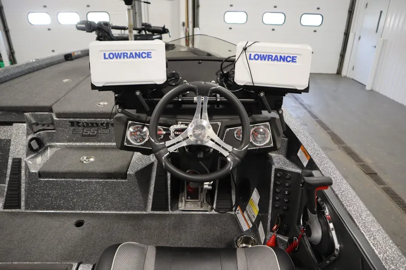 Slide: The Image of 2023 Ranger Z519 boat dashboard with Lowrance electronics and steering wheel in a garage setting. - 28