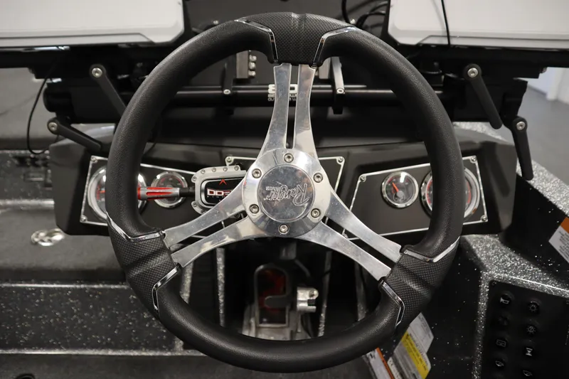 Slide: The Image of Steering wheel and dashboard of 2023 Ranger Z519 boat, featuring modern gauges and controls. - 29