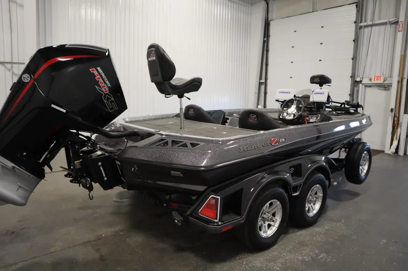 Slide: The Image of 2023 Ranger Z519 boat with powerful engine in a garage setting. - 5