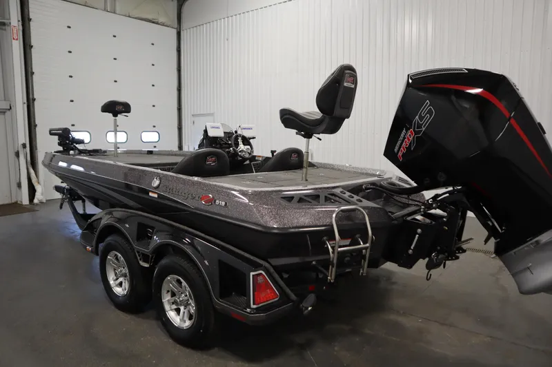 Slide: The Image of 2023 Ranger Z519 boat in a garage, featuring a sleek design and powerful motor. - 7