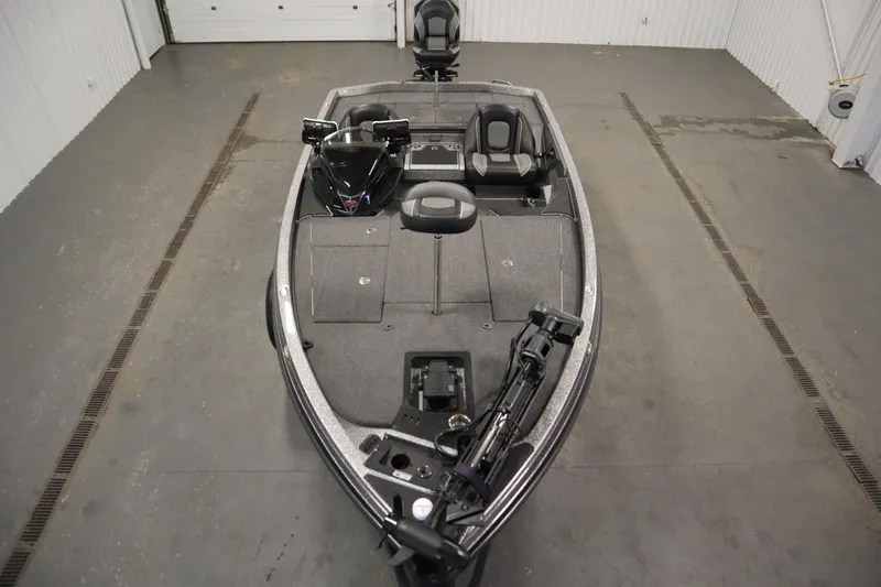 Slide: The Image of 2023 Ranger Z519 boat in a garage, featuring spacious deck and seating. - 9