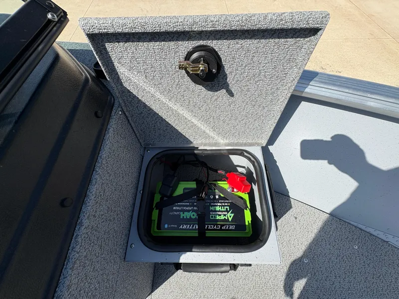 Slide: The Image of Battery compartment of 2025 Lund 1875 Alaskan Sport boat, featuring deep cycle lithium battery. - 10