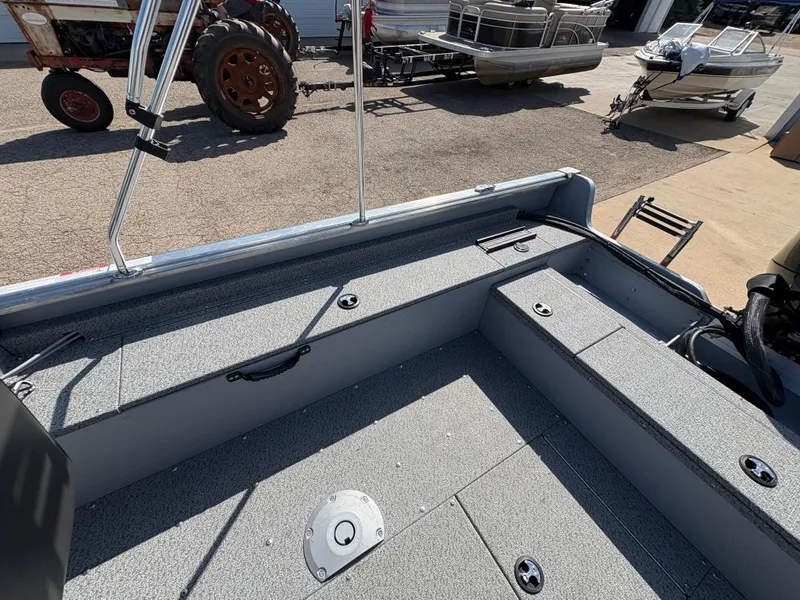 Slide: The Image of 2025 Lund 1875 Alaskan Sport boat interior with storage compartments and fishing rod holders. - 21