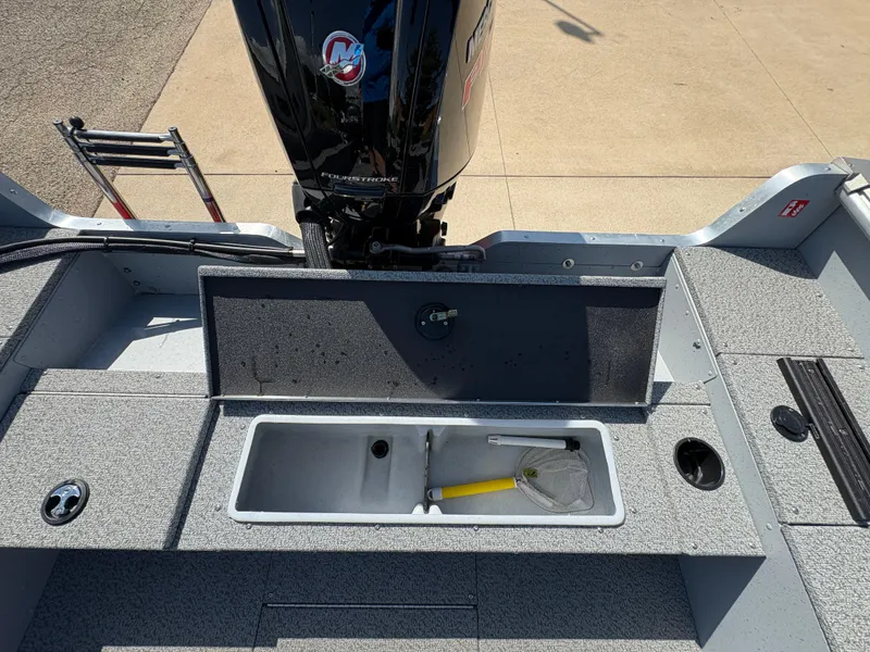 Slide: The Image of 2025 Lund 1875 Alaskan Sport boat with open storage compartment and outboard motor. - 26