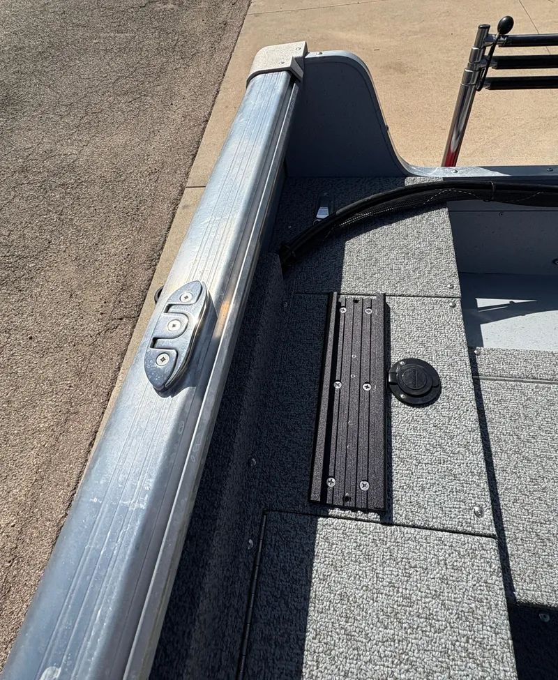 Slide: The Image of 2025 Lund 1875 Alaskan Sport boat interior, featuring durable flooring and sleek metal rail. - 29