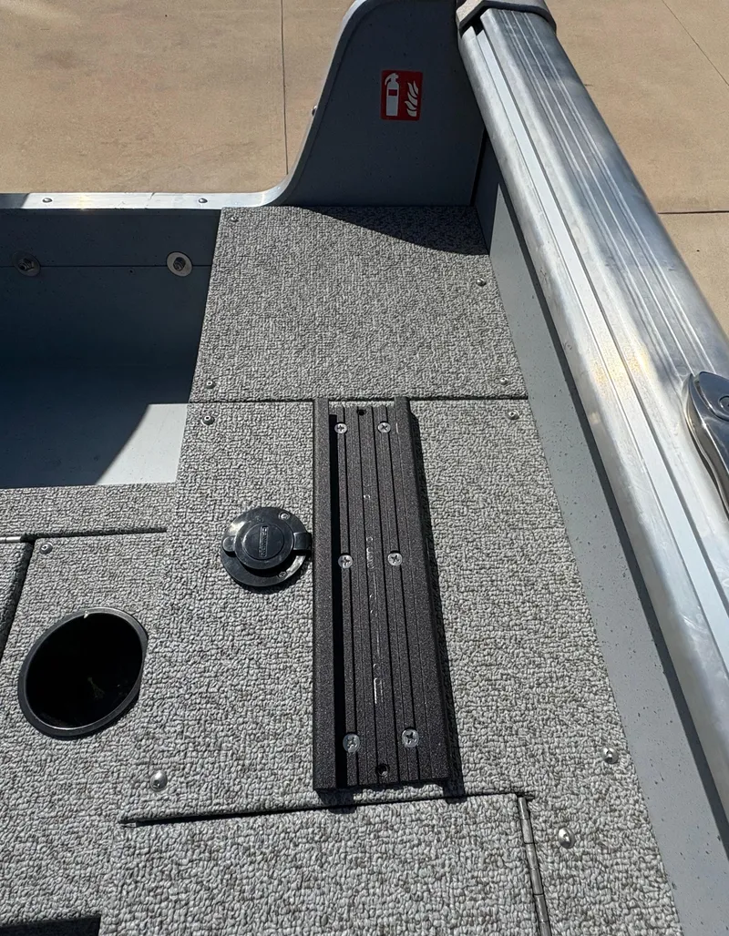 Slide: The Image of 2025 Lund 1875 Alaskan Sport boat interior with textured flooring and storage compartments. - 30