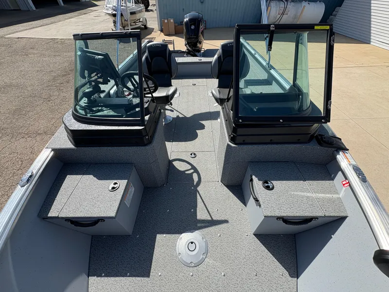 Slide: The Image of 2025 Lund 1875 Alaskan Sport boat interior with dual consoles and seating. - 8