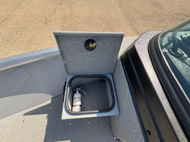 Slide: The Image of 2025 Lund 1875 Alaskan Sport boat storage compartment with fire extinguisher. - 9