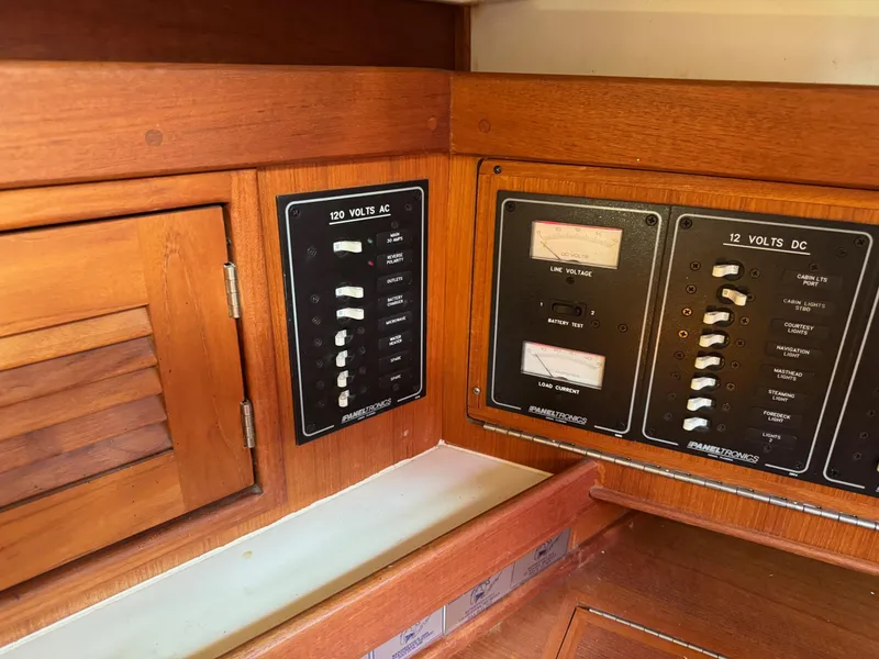 Slide: The Image of Electrical control panel on a 1997 Tartan 3500 sailboat, featuring AC and DC switches. - 17