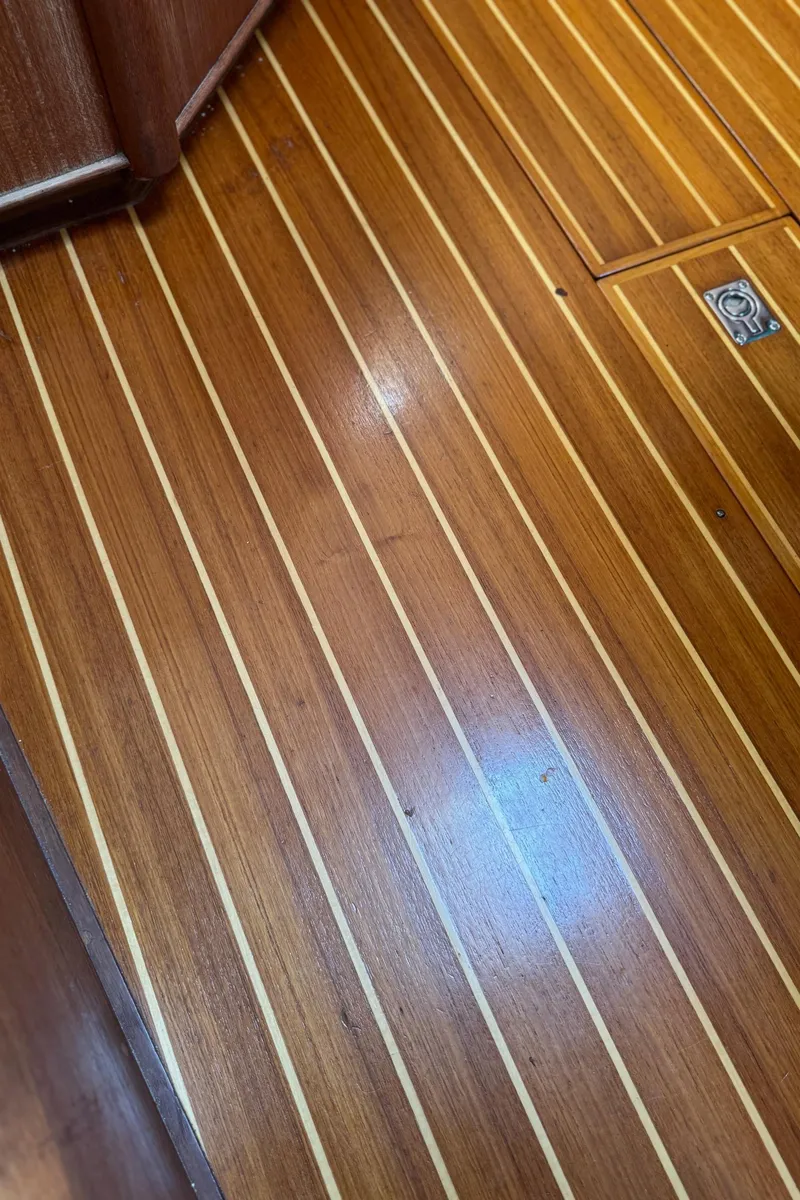 Slide: The Image of Polished wooden floor of a 1997 Tartan 3500 yacht interior. - 26
