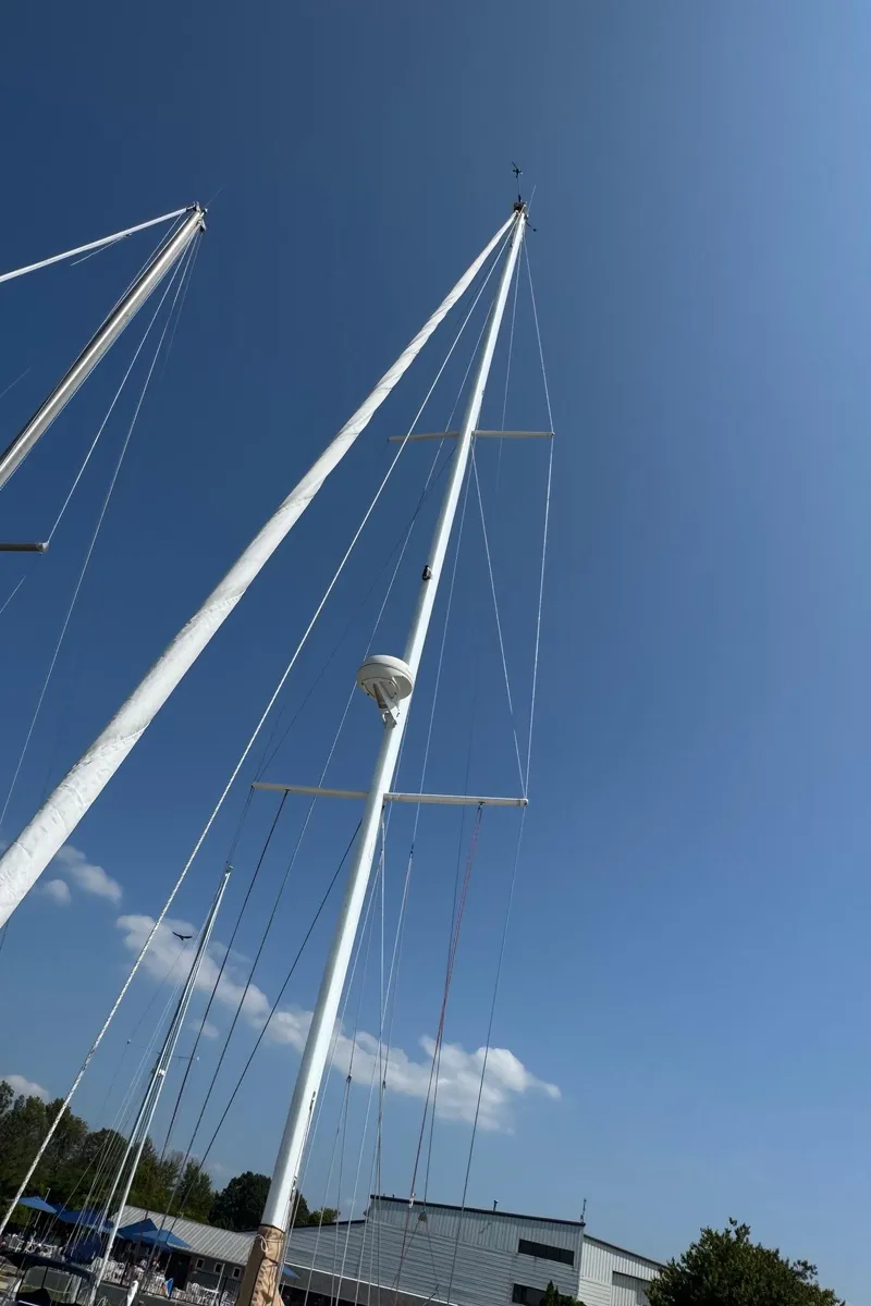 Slide: The Image of Tall sailboat mast of a 1997 Tartan 3500 against a clear blue sky. - 27