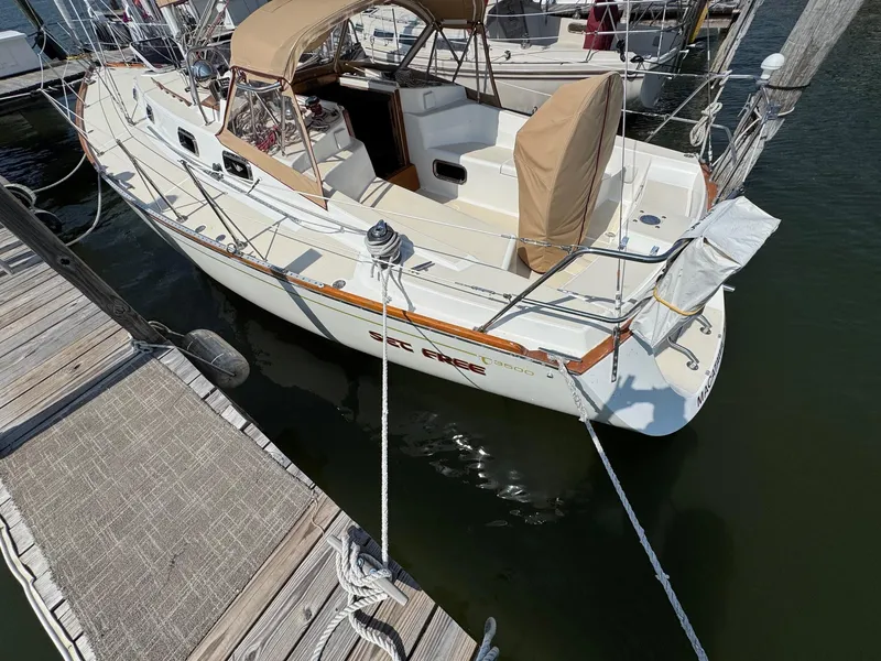 Slide: The Image of Sailboat docked at marina, Tartan 3500 model, 1997, with beige covers and wooden accents. - 4