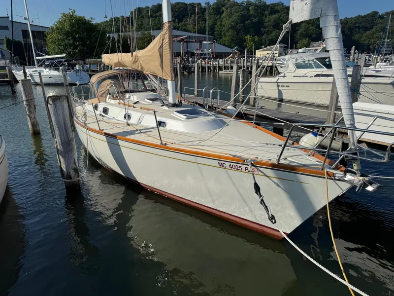 Slide: The Image of Sailboat Tartan 3500, 1997 model, docked at marina with trees in background. - 5