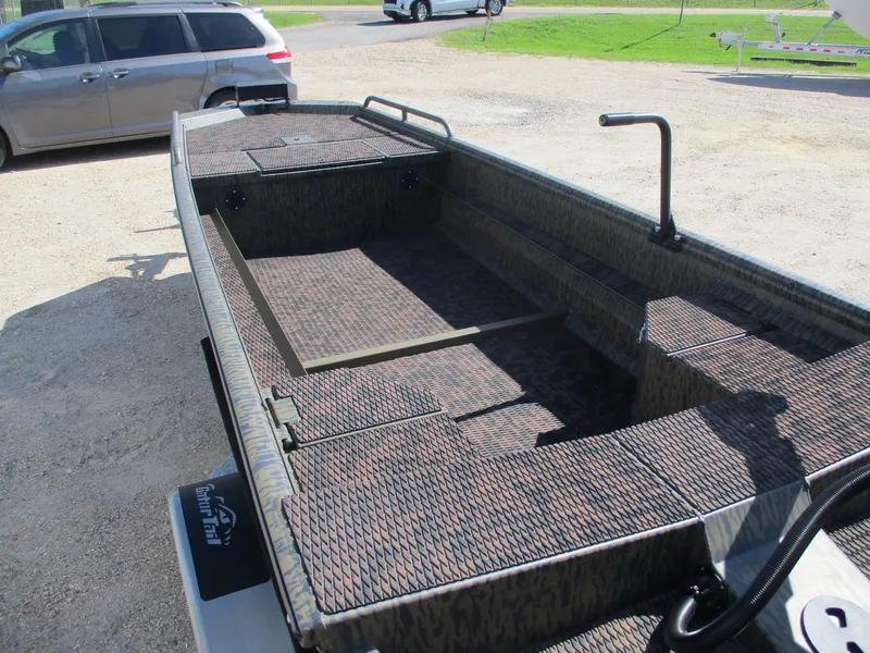 Slide: The Image of 2025 Gator Tail 1750 Savage boat with camo pattern interior, parked outdoors. - 11
